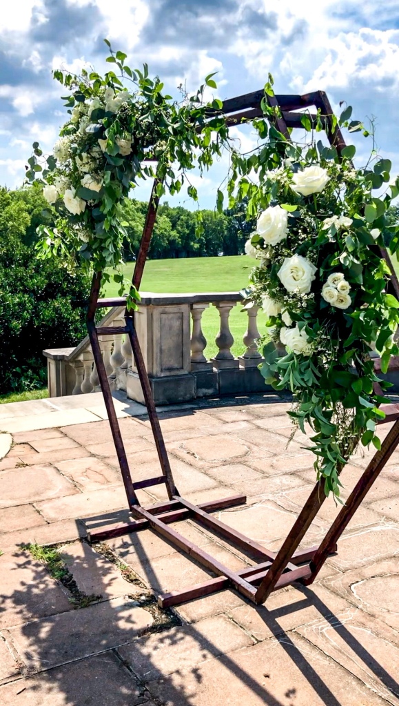 White and green flower ceremony arch hexagon
